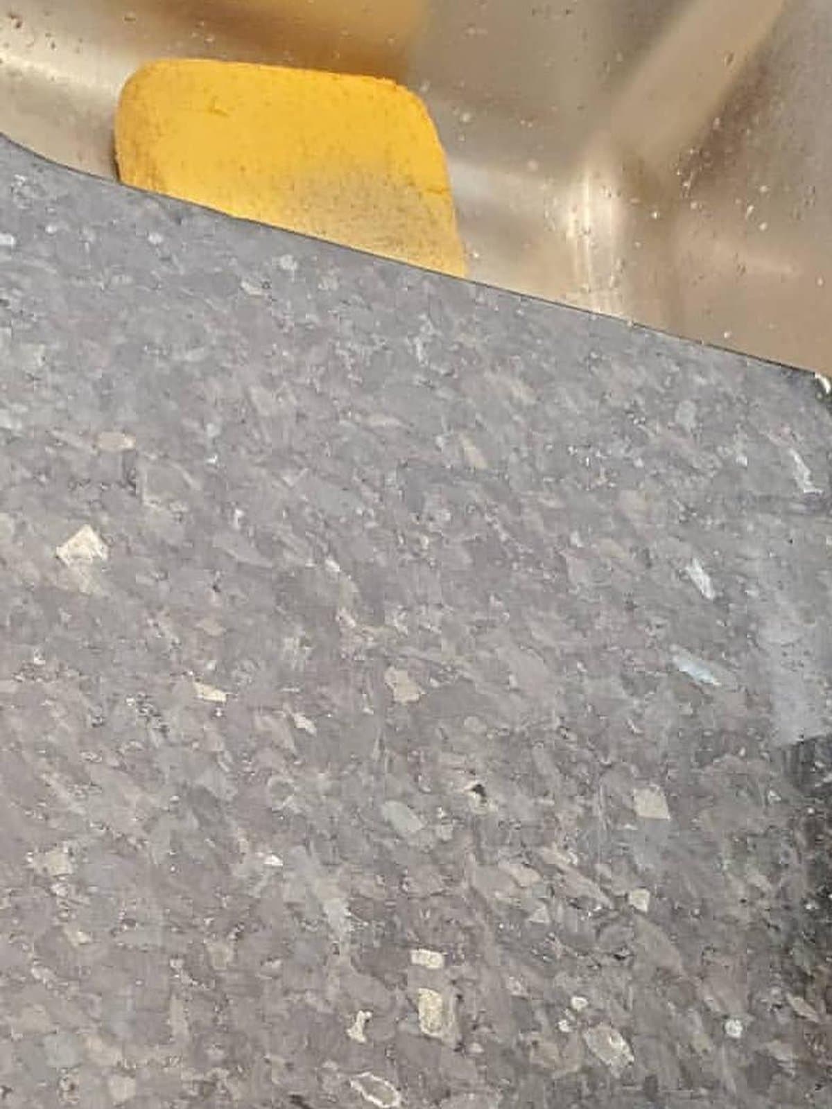 Granite countertop with a hazy, dull surface before restoration