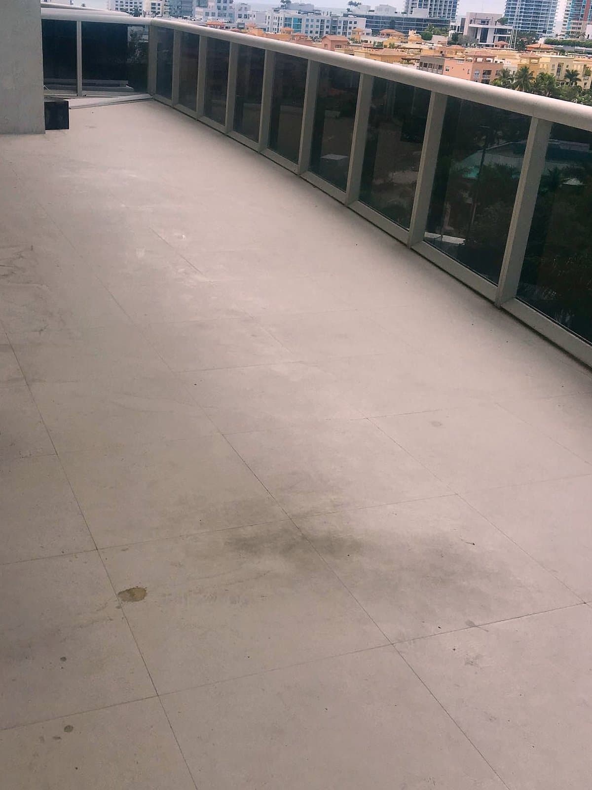 Stained, weathered limestone balcony floor before restoration